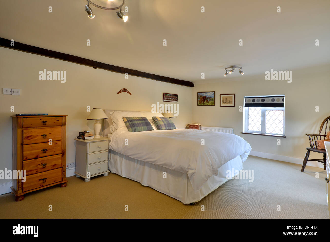 Weißes Schlafzimmer mit Doppelbett und Kommode Kiefer Stockfoto