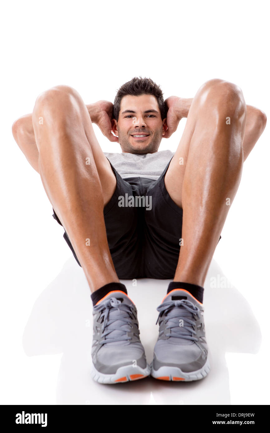 Sportlicher Mann läuft isoliert dabei Bauchmuskeln, auf einem weißen Hintergrund Stockfoto