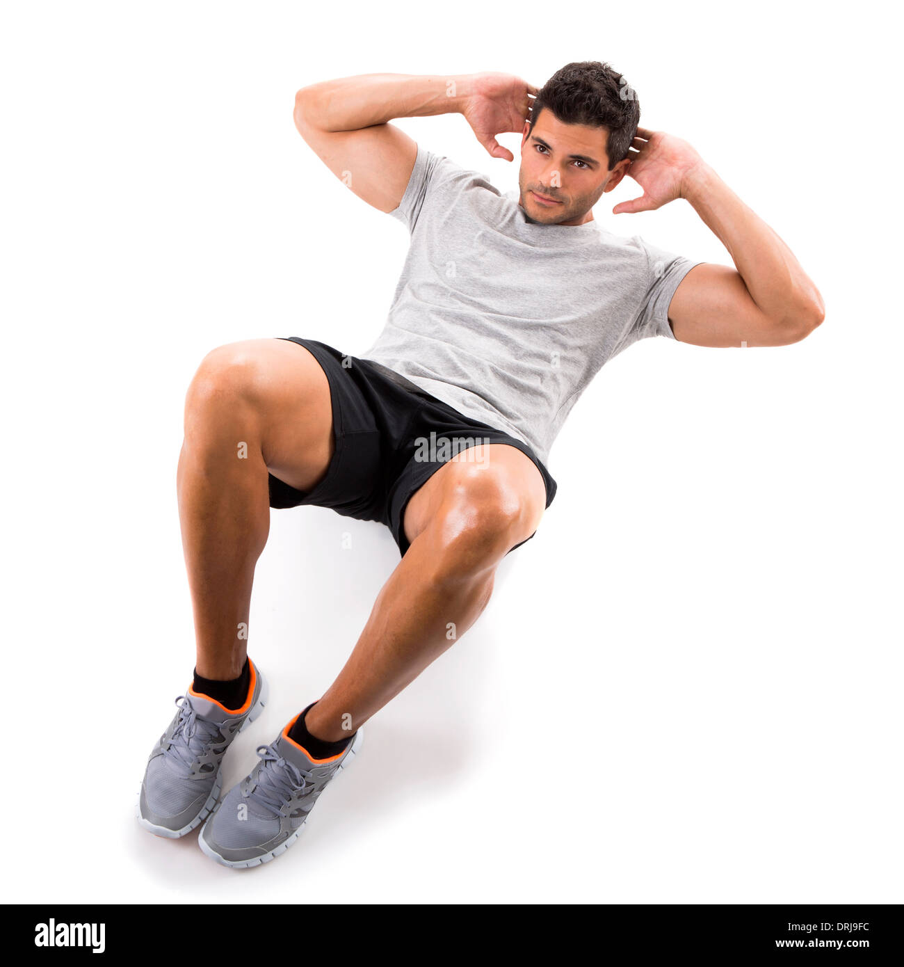 Sportlicher Mann läuft isoliert dabei Bauchmuskeln, auf einem weißen Hintergrund Stockfoto