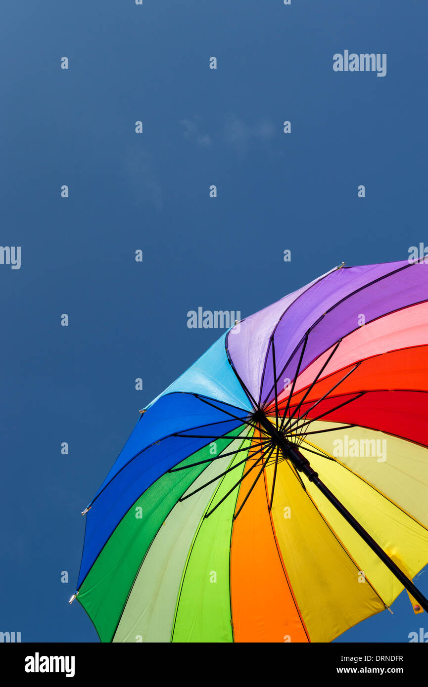 Regenbogen farbige Schirm gegen blauen Himmel Stockfoto