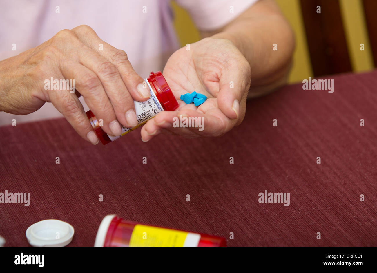 Weibliche 74 Jahre alte Senioren organisiert ihre verschreibungspflichtige Medikament Medikamente während zu Hause Stockfoto