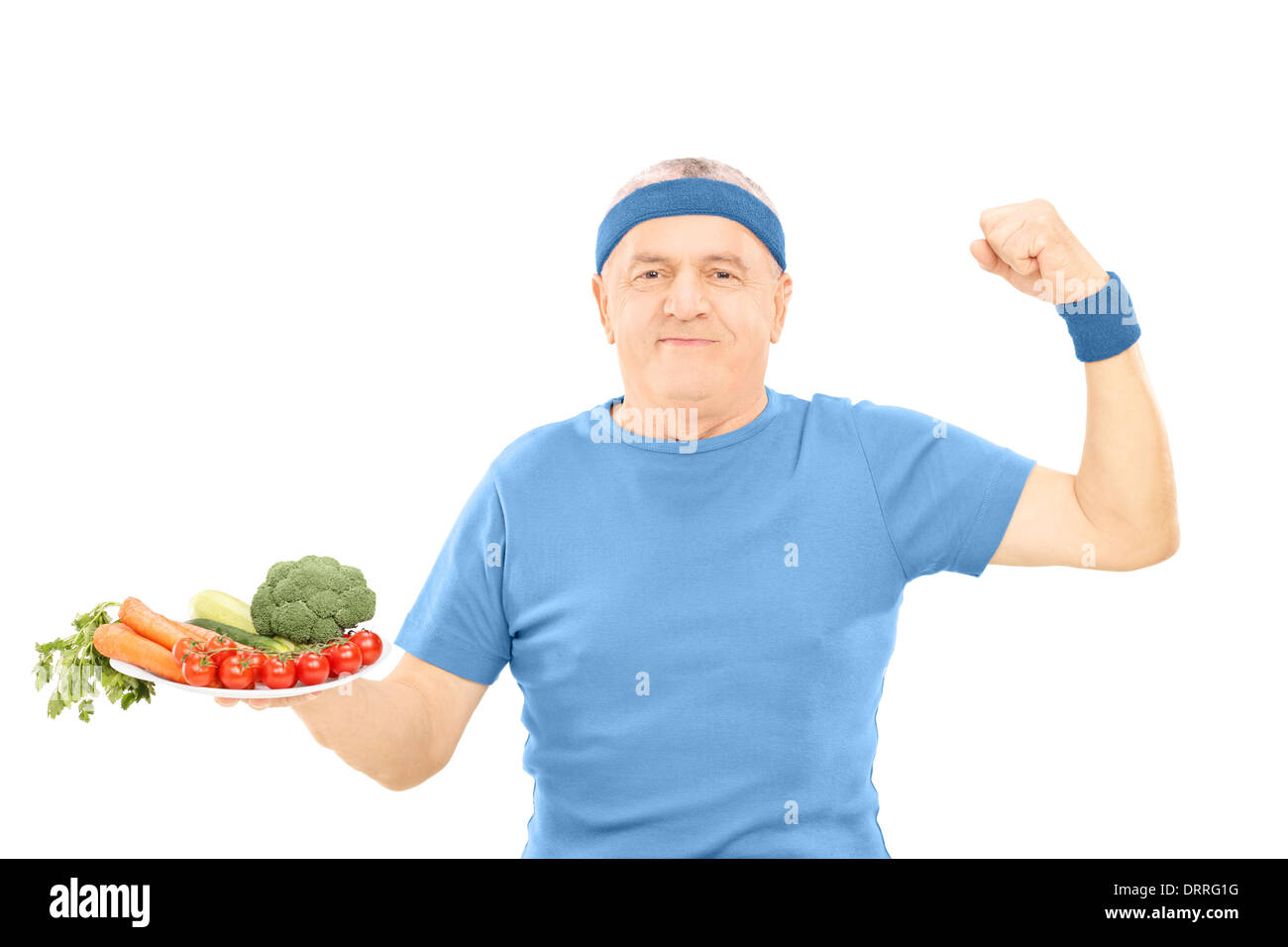 Reifer Mann Halteplatte voll mit Gemüse und zeigt Stärke Stockfoto