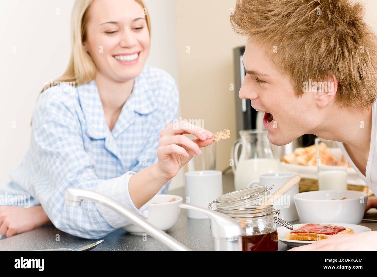 Frühstück glückliche Paar Frau Mann Getreide zu füttern Stockfoto