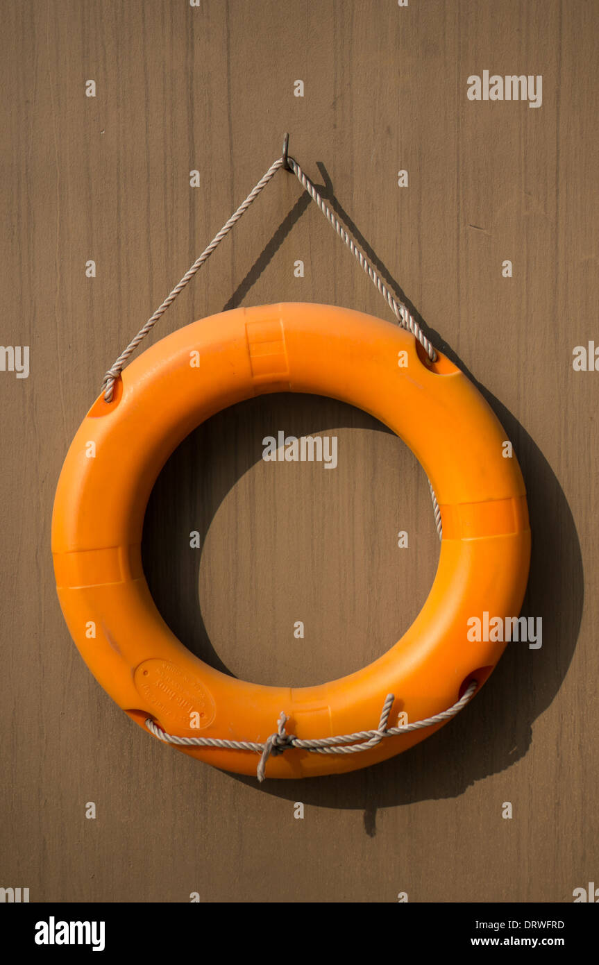 Auffallende orange Rettungsring im Swimmingpool des Hotels Stockfoto