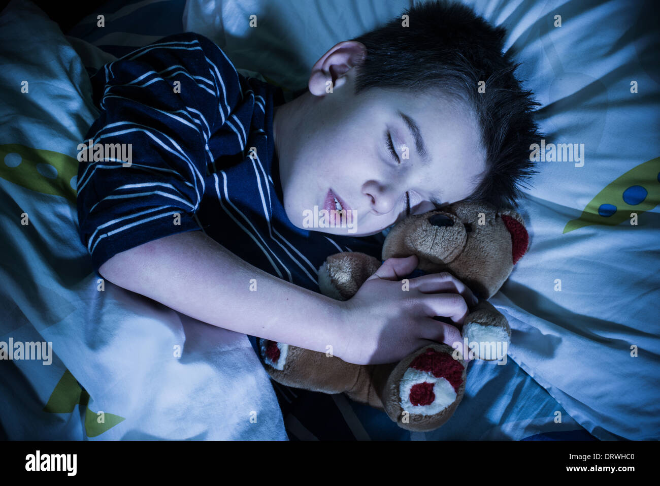 Schlafendes Kind mit seinem Spielzeug Bär. Stockfoto