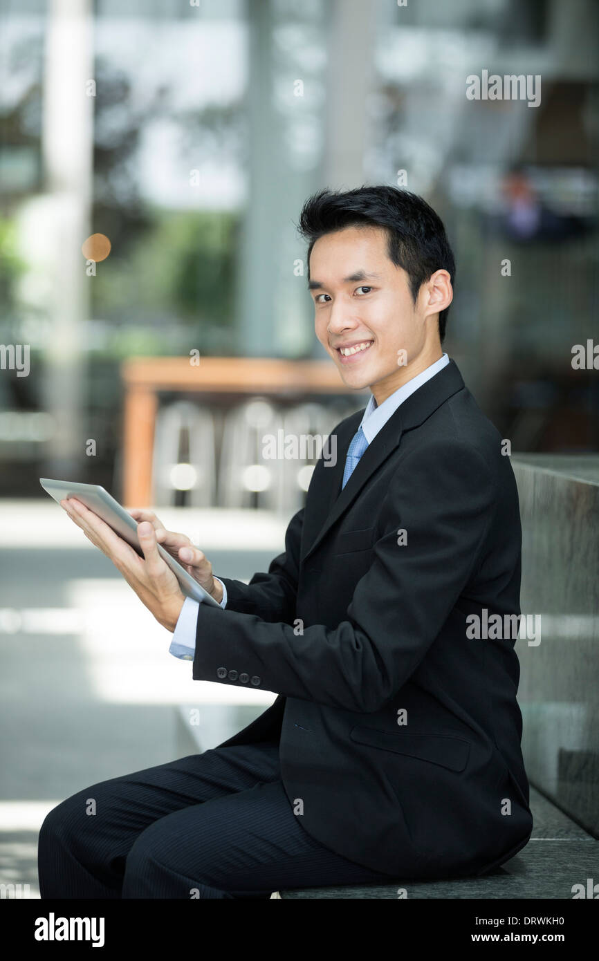 Chinesischer Mann mit einem Tabletcomputer. Asiatische Geschäftsmann mit digitalen Tablet-Computer vor. Stockfoto