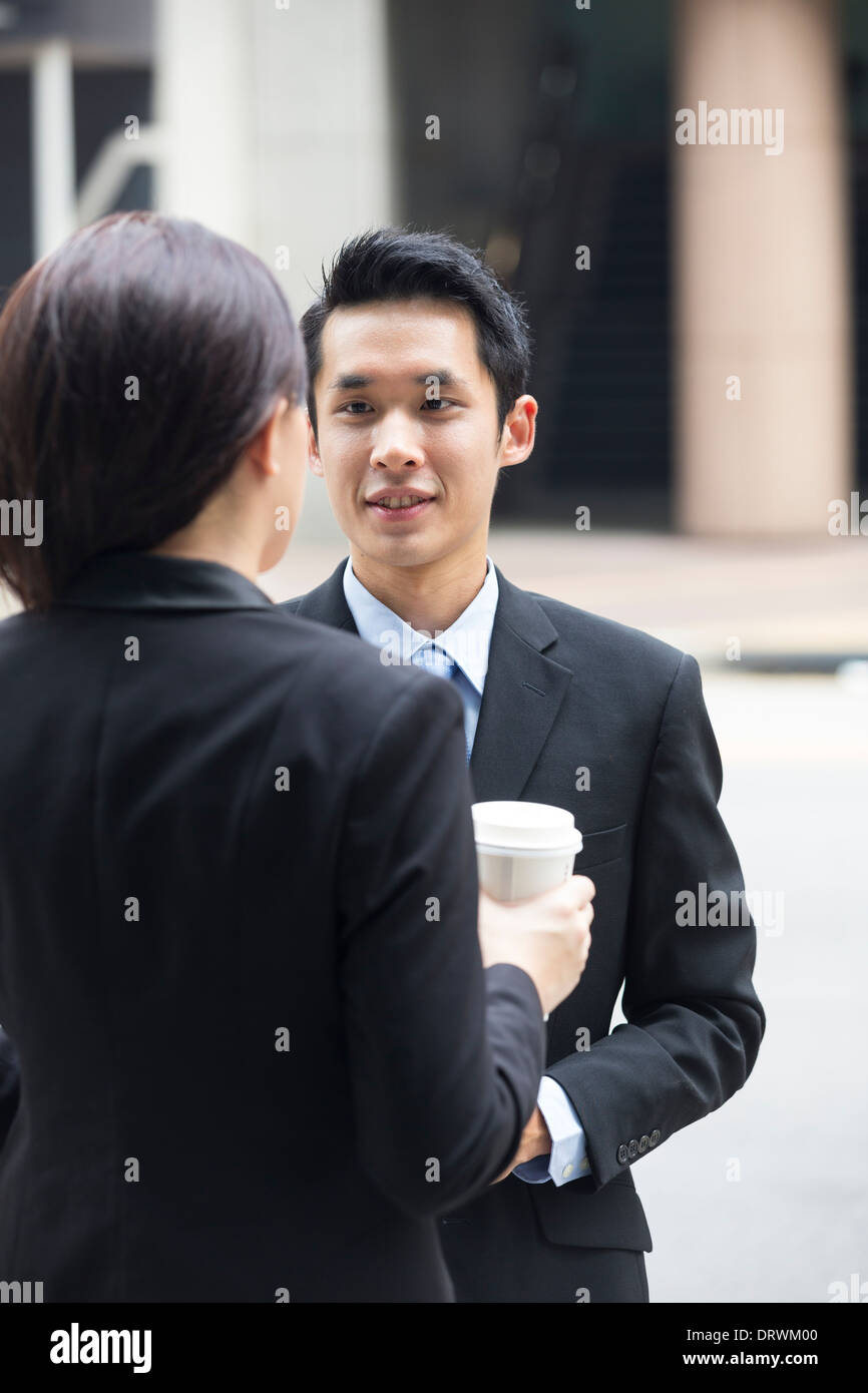 Glücklich chinesischen Geschäftspartnern außerhalb des Büros miteinander zu reden. Stockfoto