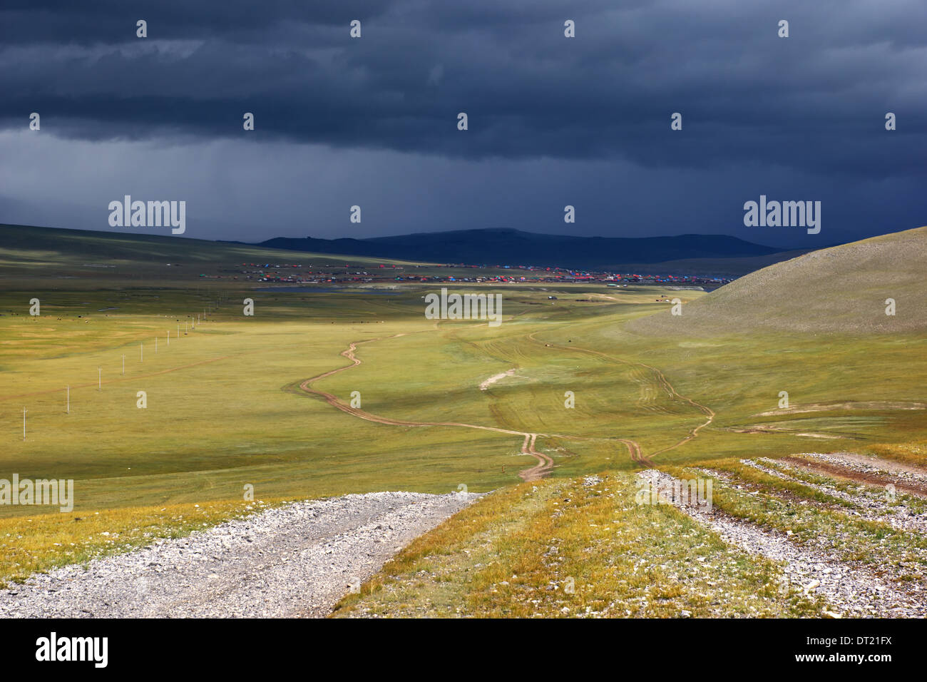 Straßen in den Wüsten Steppen der Mongolei, Dorf am Horizont und der Sturm-Himmel Stockfoto
