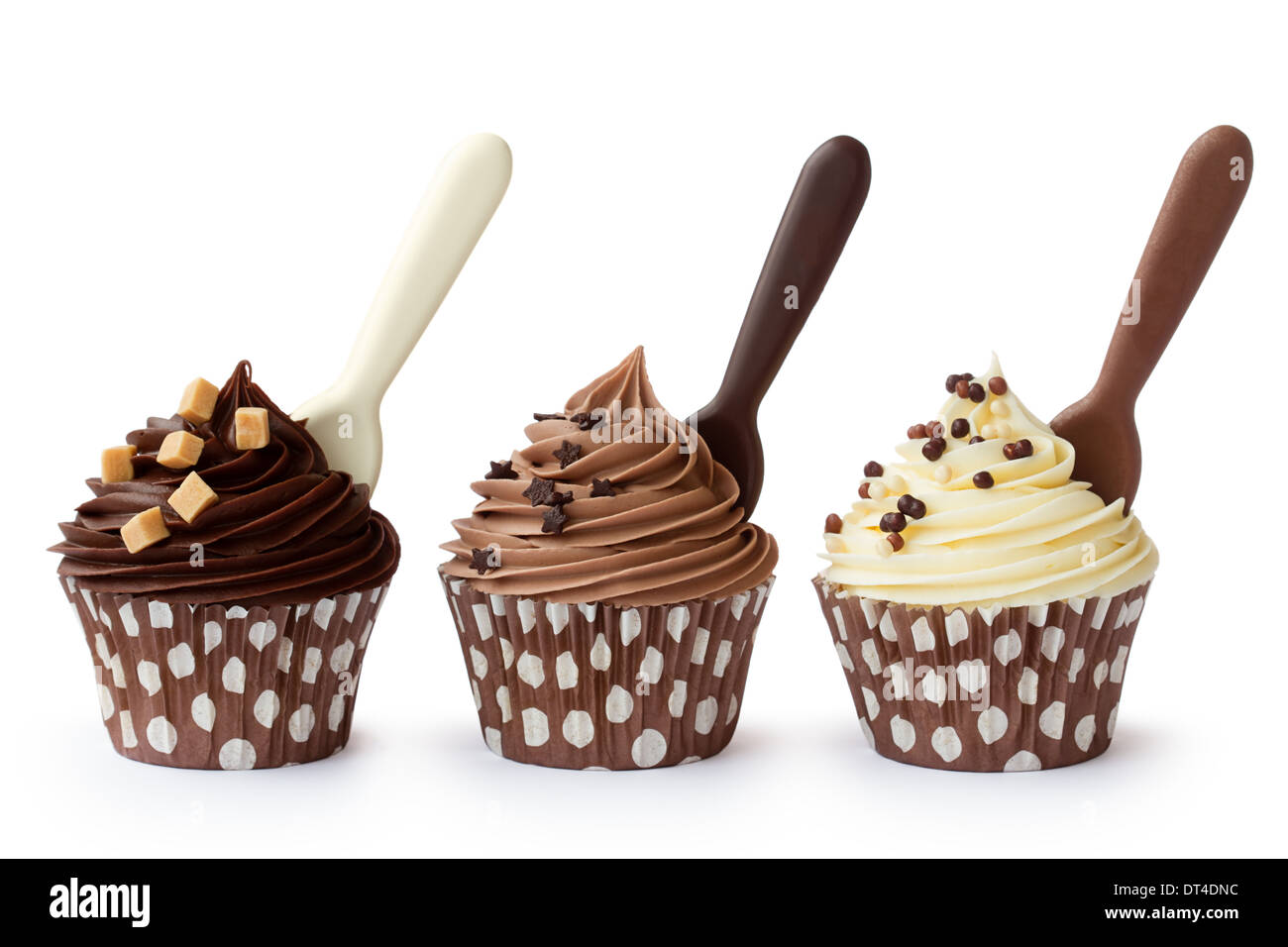 Muffins mit weißer, Milch- und dunkle Schokolade Zuckerguss verziert Stockfoto