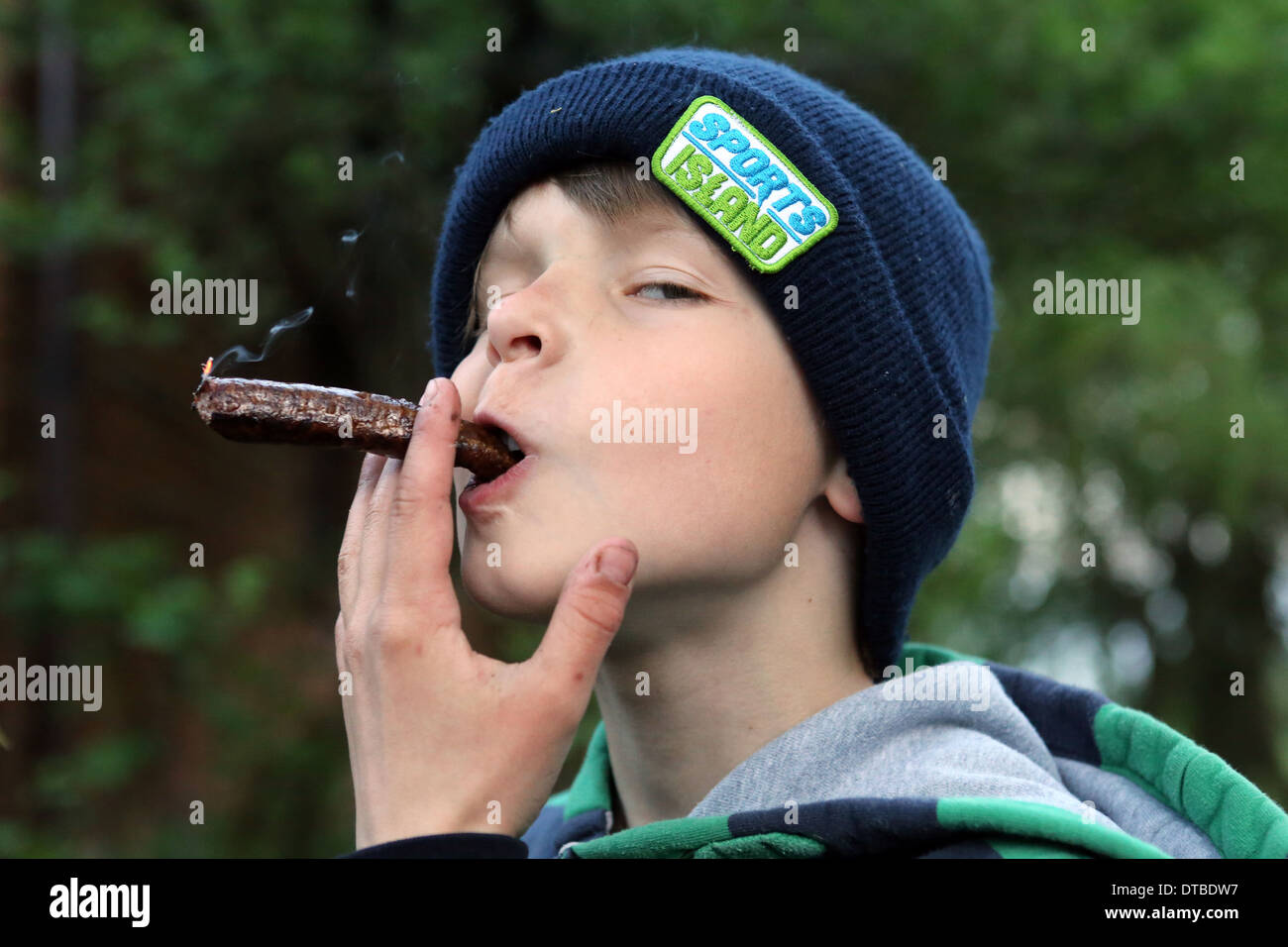 Neu Kätwin, Deutschland, junge spielt mit einem verkohlten Würstchen Stockfoto