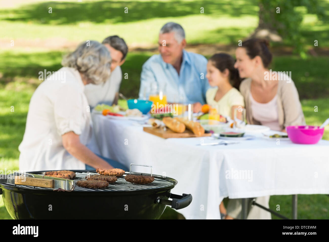 Barbecue-Grill mit Großfamilie mit Mittagessen im park Stockfoto