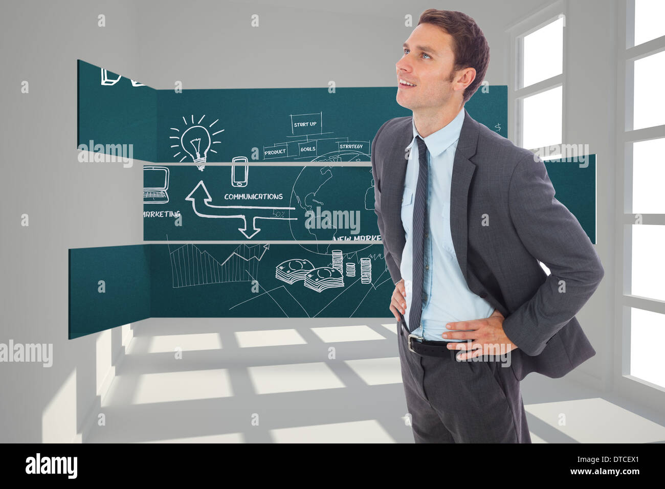 Zusammengesetztes Bild von fröhlich Geschäftsmann stehend mit Händen auf den Hüften Stockfoto