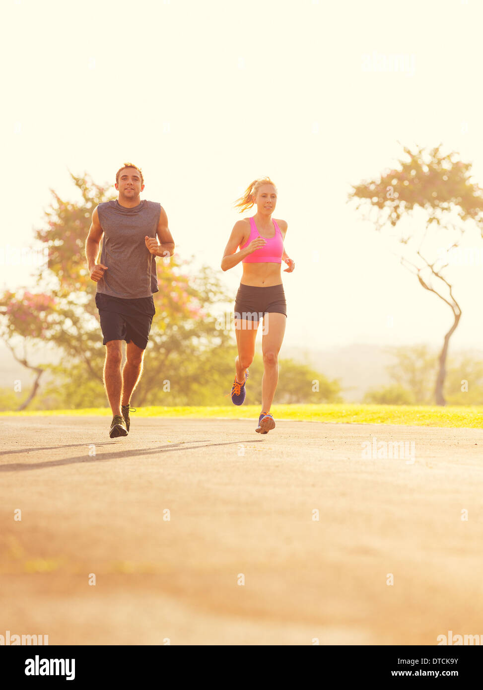 Sportliche paar zusammen laufen bei Sonnenaufgang. Sport-Läufer Joggen im Park trail in den frühen Morgenstunden. Gesunder Lebensstil fitness Stockfoto