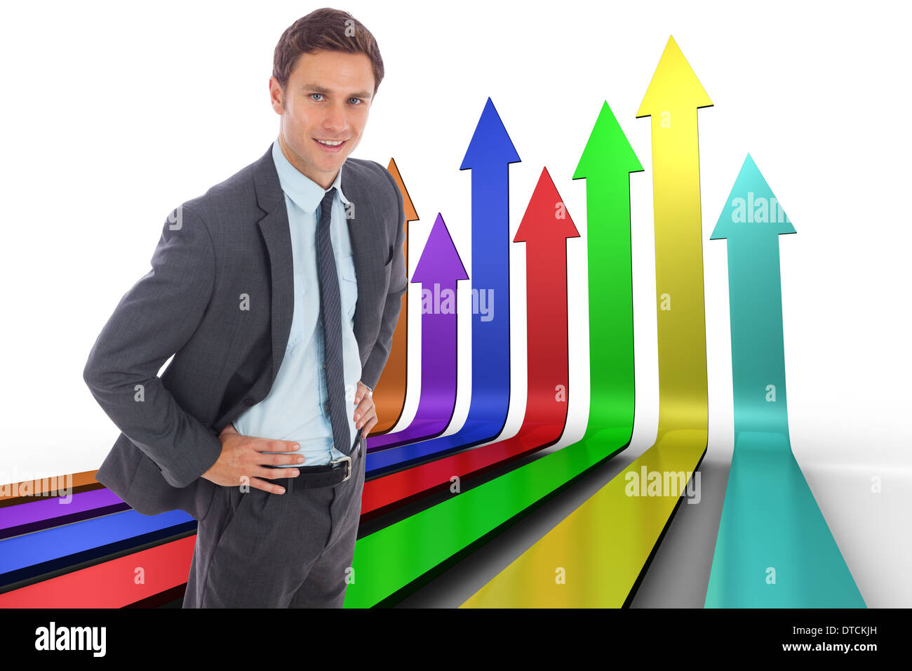 Zusammengesetztes Bild von fröhlich Geschäftsmann stehend mit Händen auf den Hüften Stockfoto