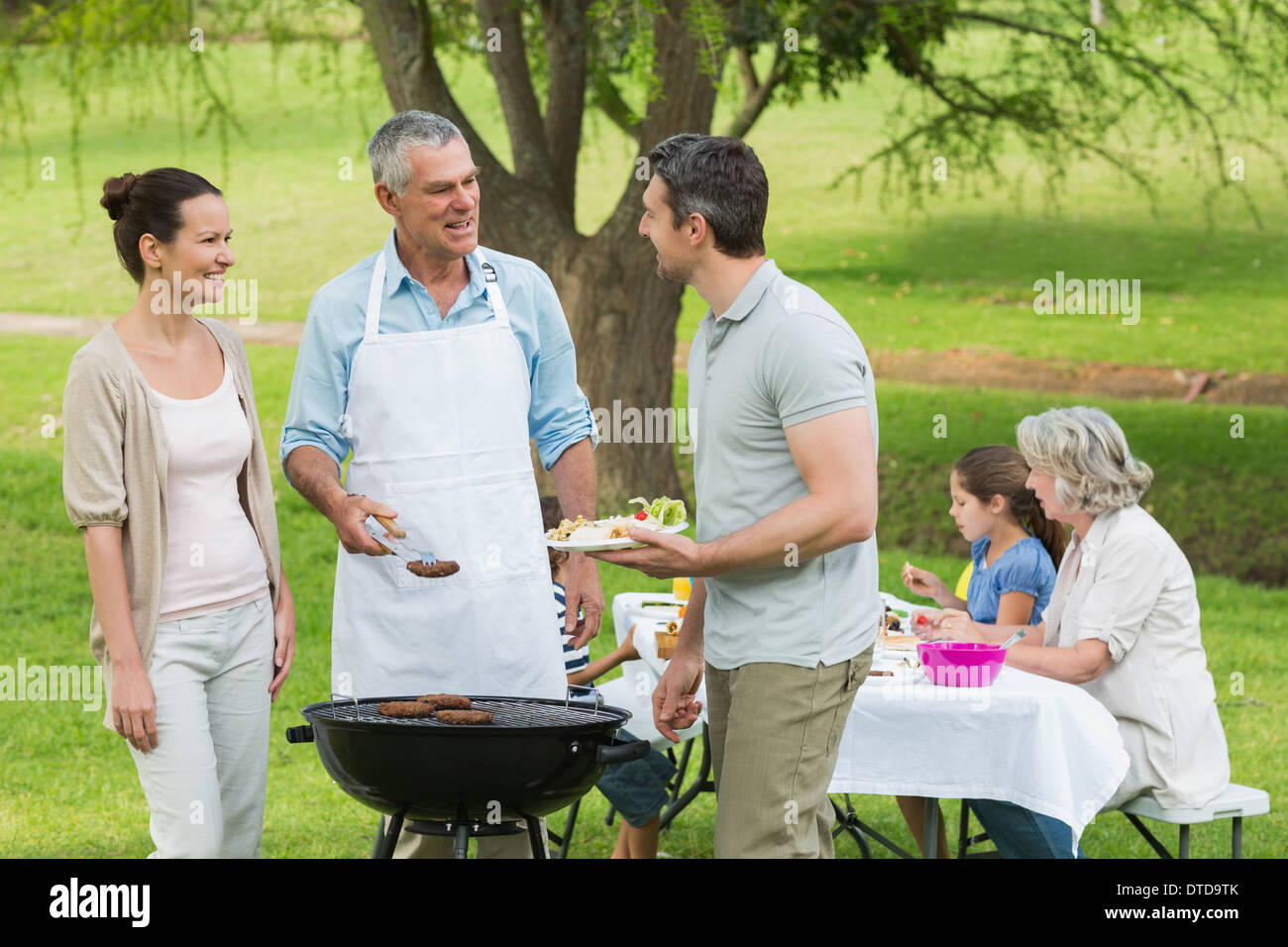 Großfamilie mit Grillen im park Stockfoto