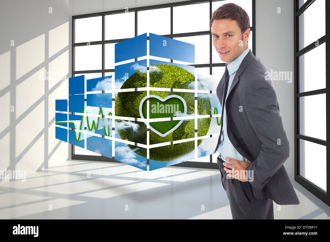 Zusammengesetztes Bild von fröhlich Geschäftsmann stehend mit Händen auf den Hüften Stockfoto