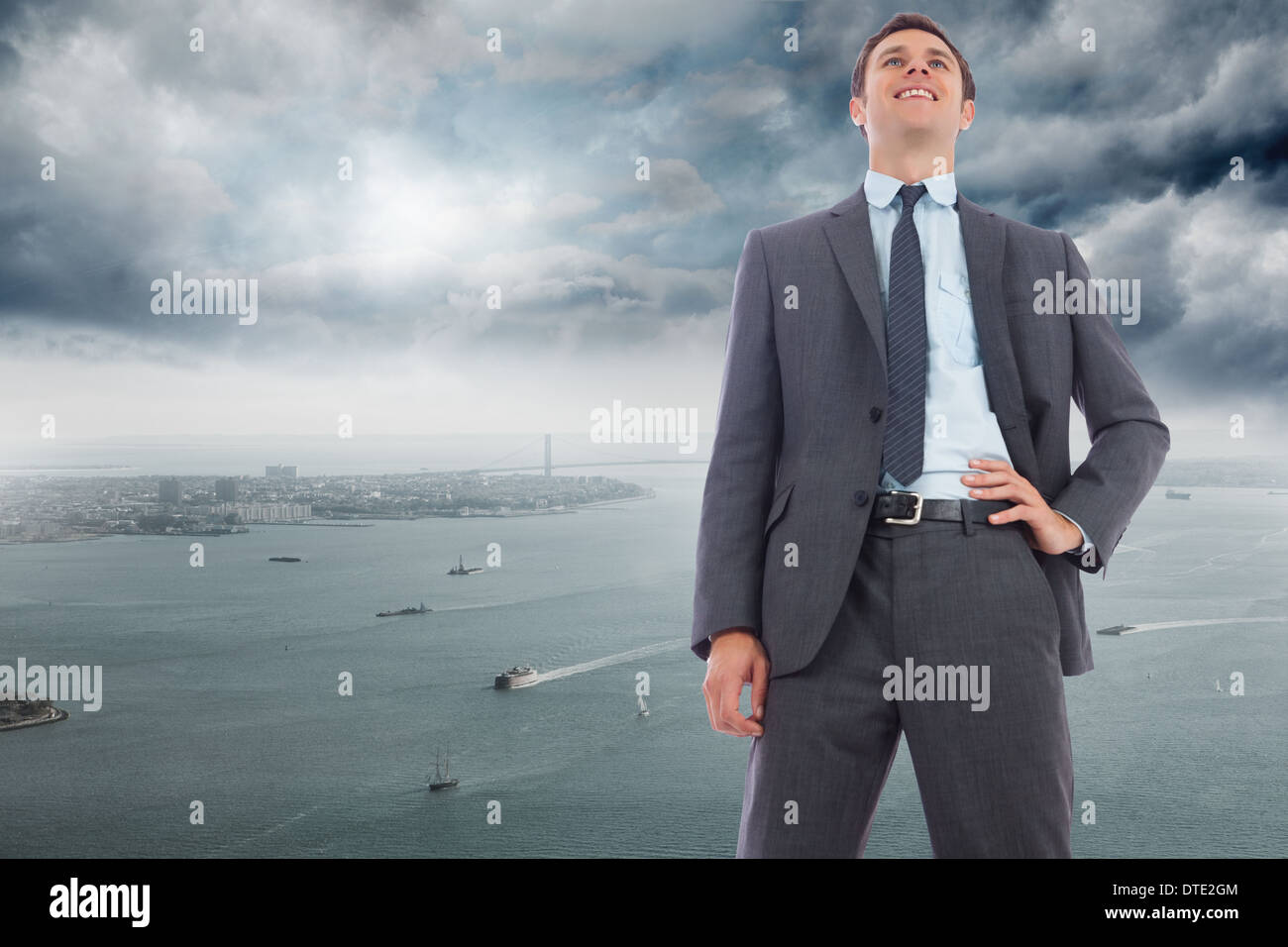 Zusammengesetztes Bild von fröhlich Geschäftsmann mit Hand auf Hüfte Stockfoto