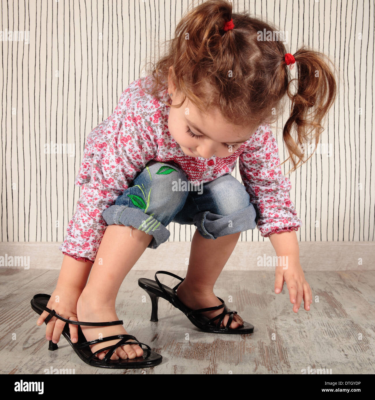 ein kleines Mädchen mit Mama Schuhe Stockfoto