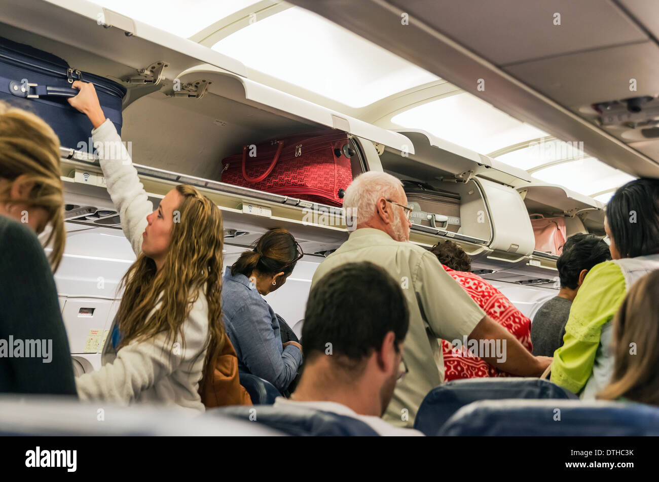 Airline Reisende Retieve Handgepäck von Gepäckfächer. Stockfoto