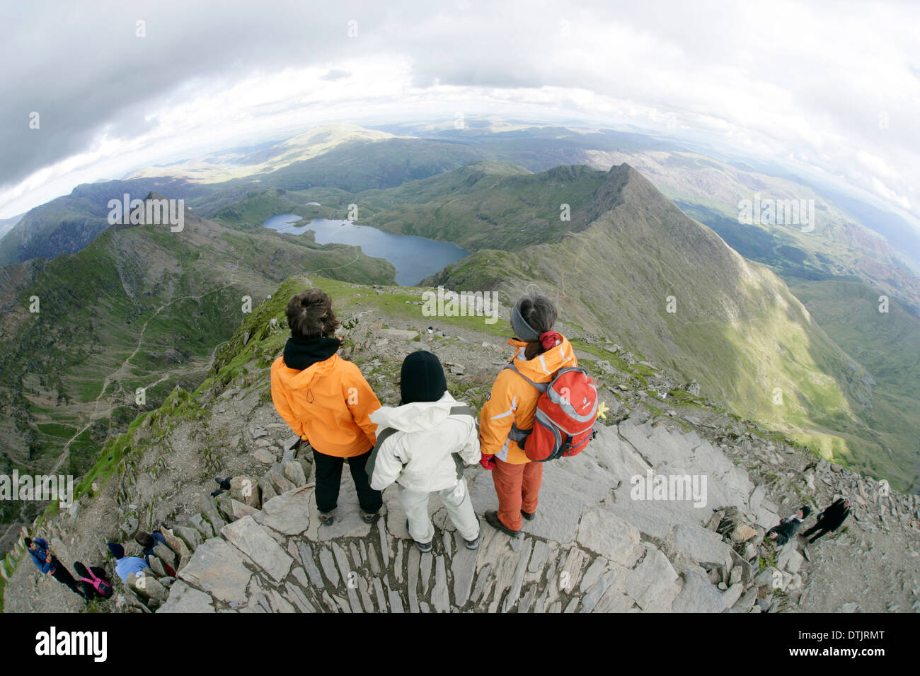 Drei Menschen standen an der Spitze eines Berges, Snowdon, Nordwales. Stockfoto