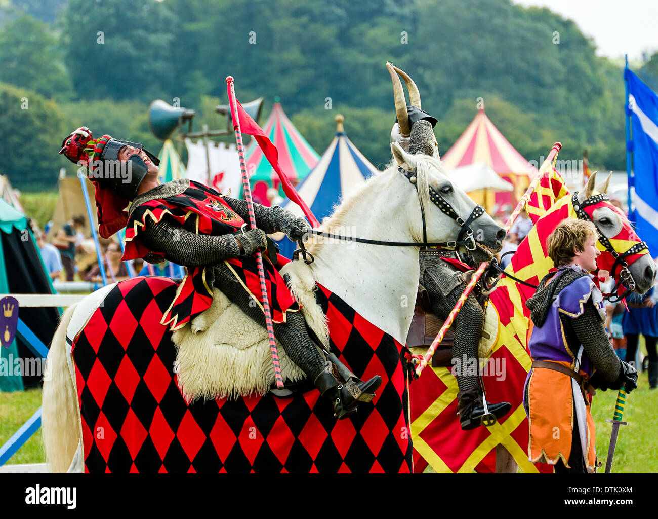 Mann auf dem Rücken der Pferde verkleidet als mittelalterliche Ritter wieder mit Lachen am Sommer Land Show lehnt sich in Somerset England Vereinigtes Königreich. Stockfoto