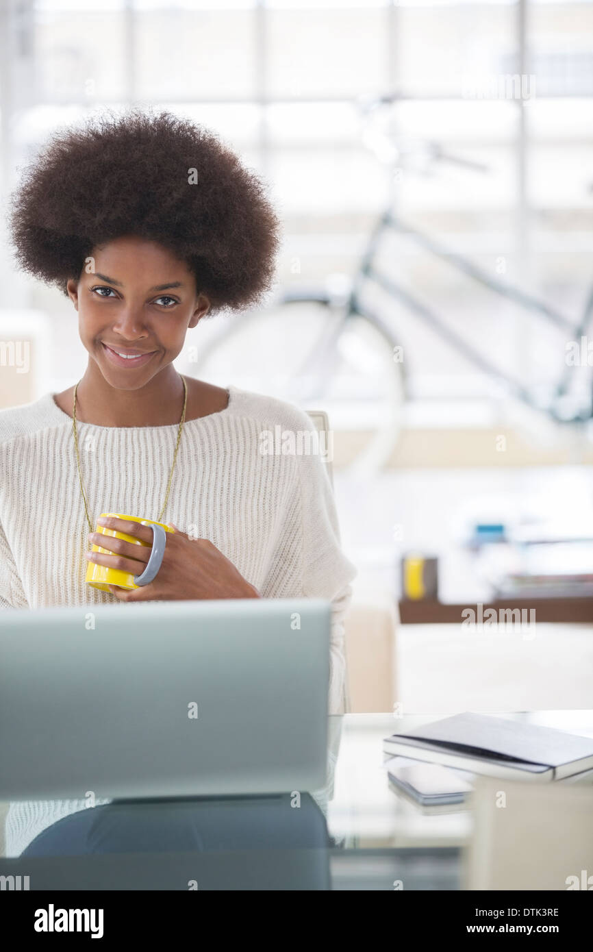 Frau mit Laptop am Schreibtisch Stockfoto