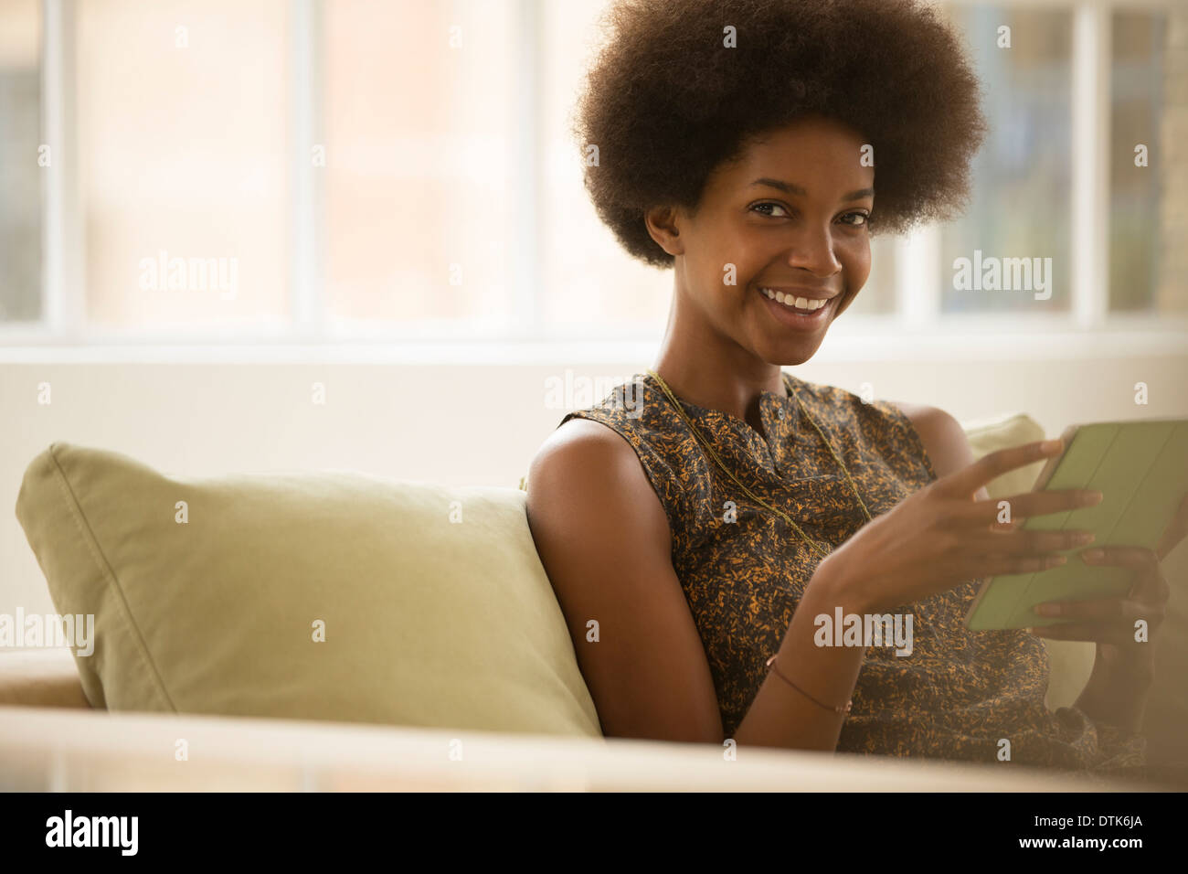 Frau mit digital-Tablette auf sofa Stockfoto