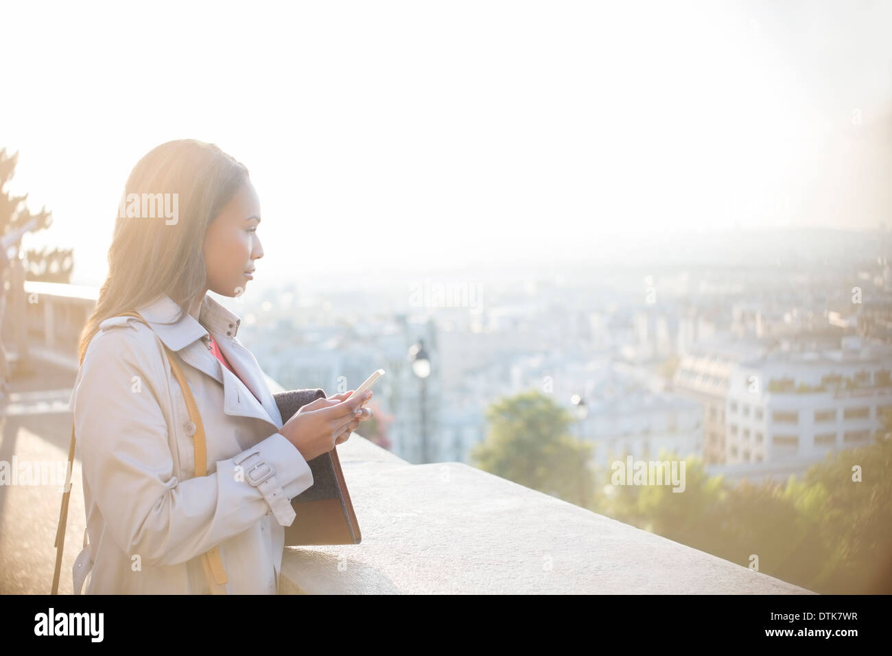 Geschäftsfrau mit Handy, mit Blick auf Paris, Frankreich Stockfoto