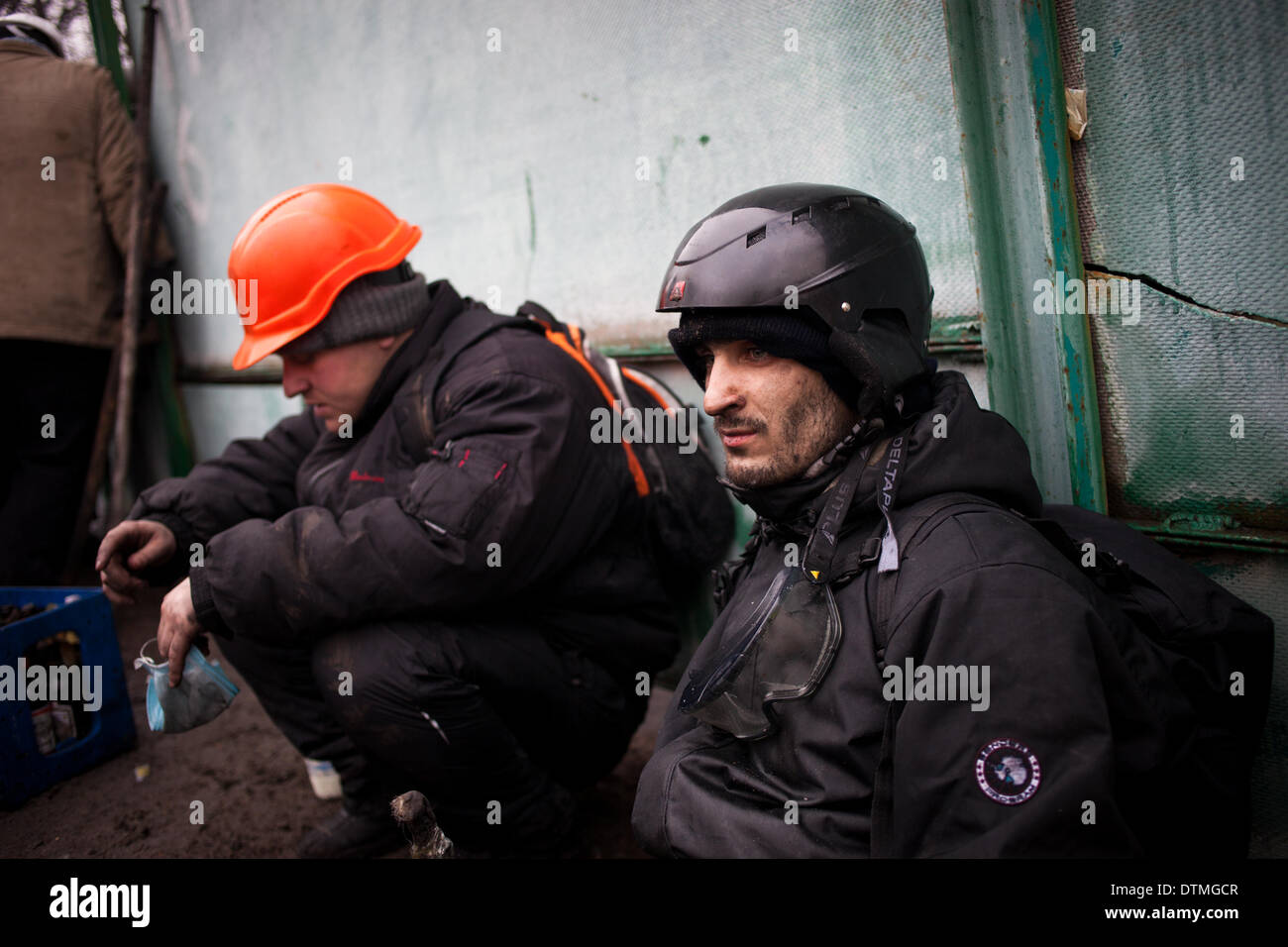 Kiew, Ukraine. 20. Februar 2014. Anti-Regierungs-Demonstranten ruhen auf dem Boden bei Zusammenstößen mit der Polizei im Zentrum von Kiew am 20. Februar 2014. Mindestens 25 Demonstranten am 20. Februar in frischen Zusammenstöße zwischen Tausenden von Demonstranten und schwer bewaffnete Bereitschaftspolizei im Herzen von Kiew ums Leben kamen, sagte AFP-Korrespondenten vor Ort. Die Leichen von acht Demonstranten außerhalb von Kiew Hauptpost auf dem Unabhängigkeitsplatz lagen, sagte ein AFP-Reporter. Die Leichen von 17 anderen Demonstranten mit scheinbaren Schusswunden waren auch in der Nähe von zwei Hotels auf gegenüberliegenden Seiten des p gesehen. Stockfoto