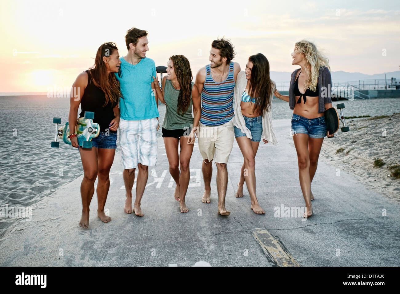 Freunde, die zusammen am Strand spazieren Stockfoto