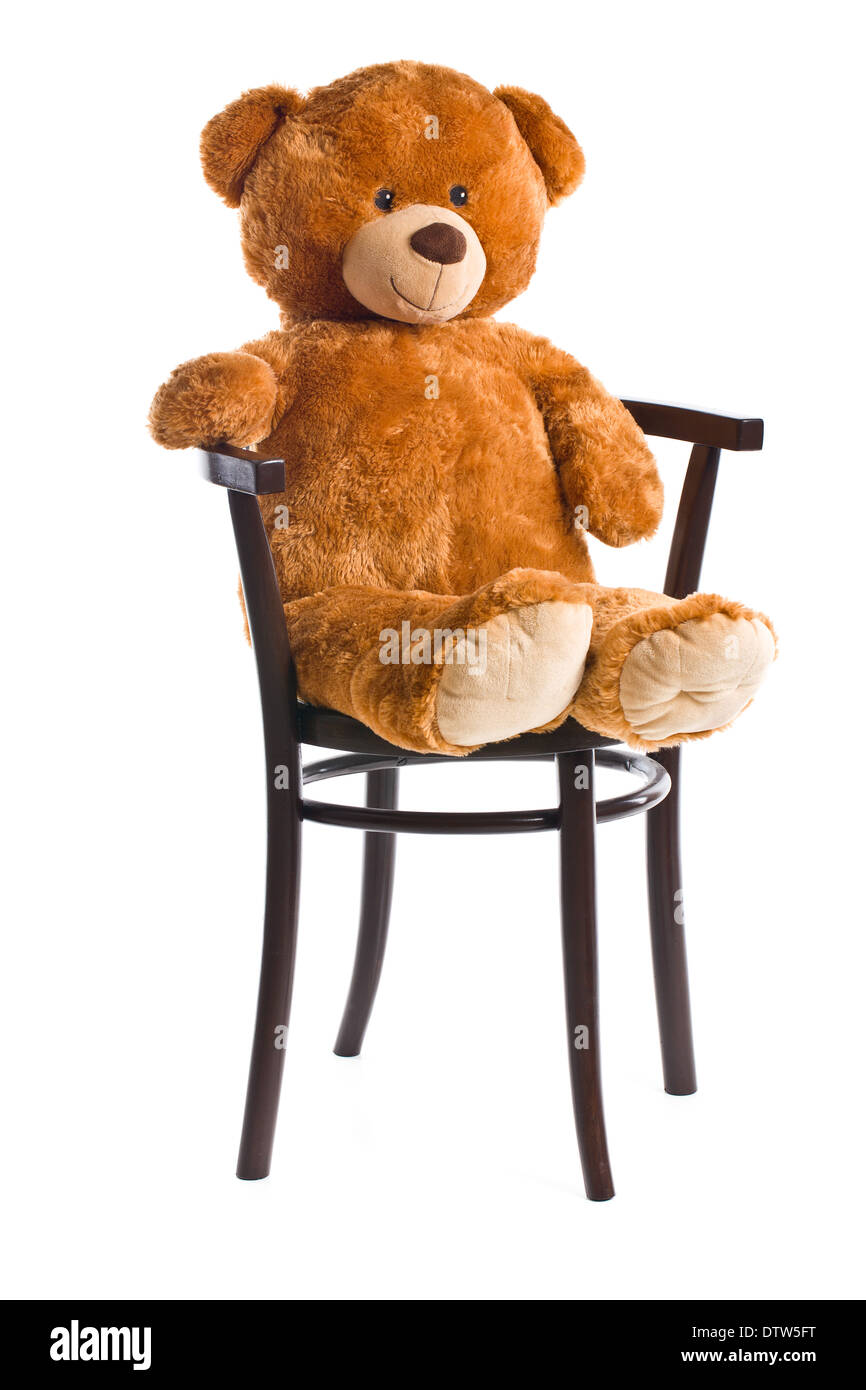 der Teddybär auf einem Stuhl sitzend Stockfoto