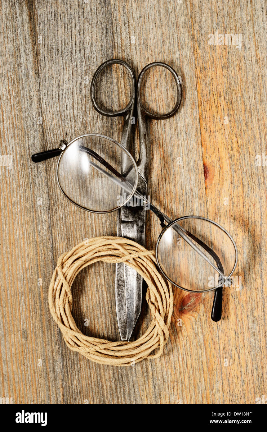 alten Schere, Gläser und Hank Bindfäden über Holz Textur Stockfoto