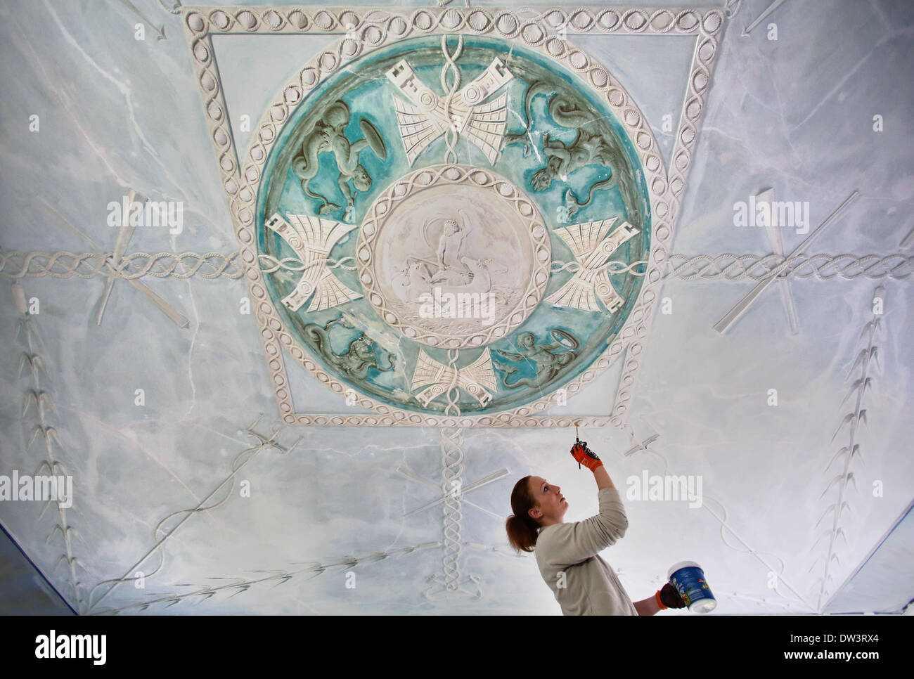 Restaurator Michelle Eicke malt Grundierung auf die Stuckdecke in der erhaltenen Suite von Marshall Georg Heinrich von Berenhorst, Wörlitz Palace in Wörlitz, Deutschland, 24. Februar 2014. Es gibt sechs andere ähnlichen Suiten aus zwei Räumen im Palast im Auftrag von Fürst Leopold Friedrich Franz von Anhalt-Dessaut. Sie werden bis 2016 restauriert. Die Zimmer wurden von den Prinzen und seine Familie sowie Marshall Berenhorst und der Architekt Erdmanndorff verwendet. Der Palast ist Teil des Weltkulturerbes der UNESCO und ist ein Beispiel des deutschen Klassizismus. Foto: Jan Woitas Stockfoto