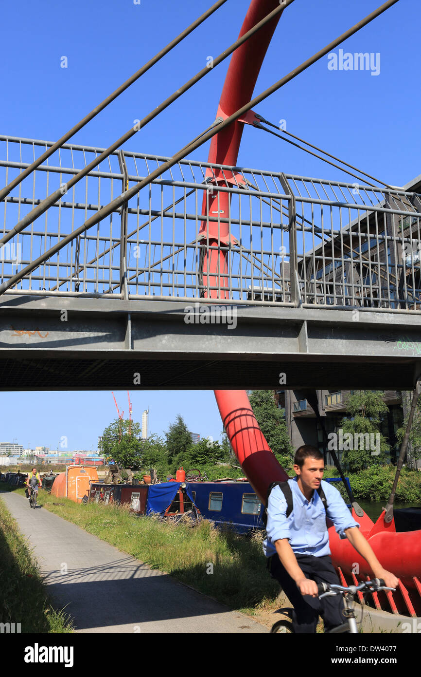 Radfahren entlang der Leinpfad am Hertford Union Kanal unter der Fußgängerbrücke zum Fisch Insel in Hackney Wick, in East London, UK Stockfoto