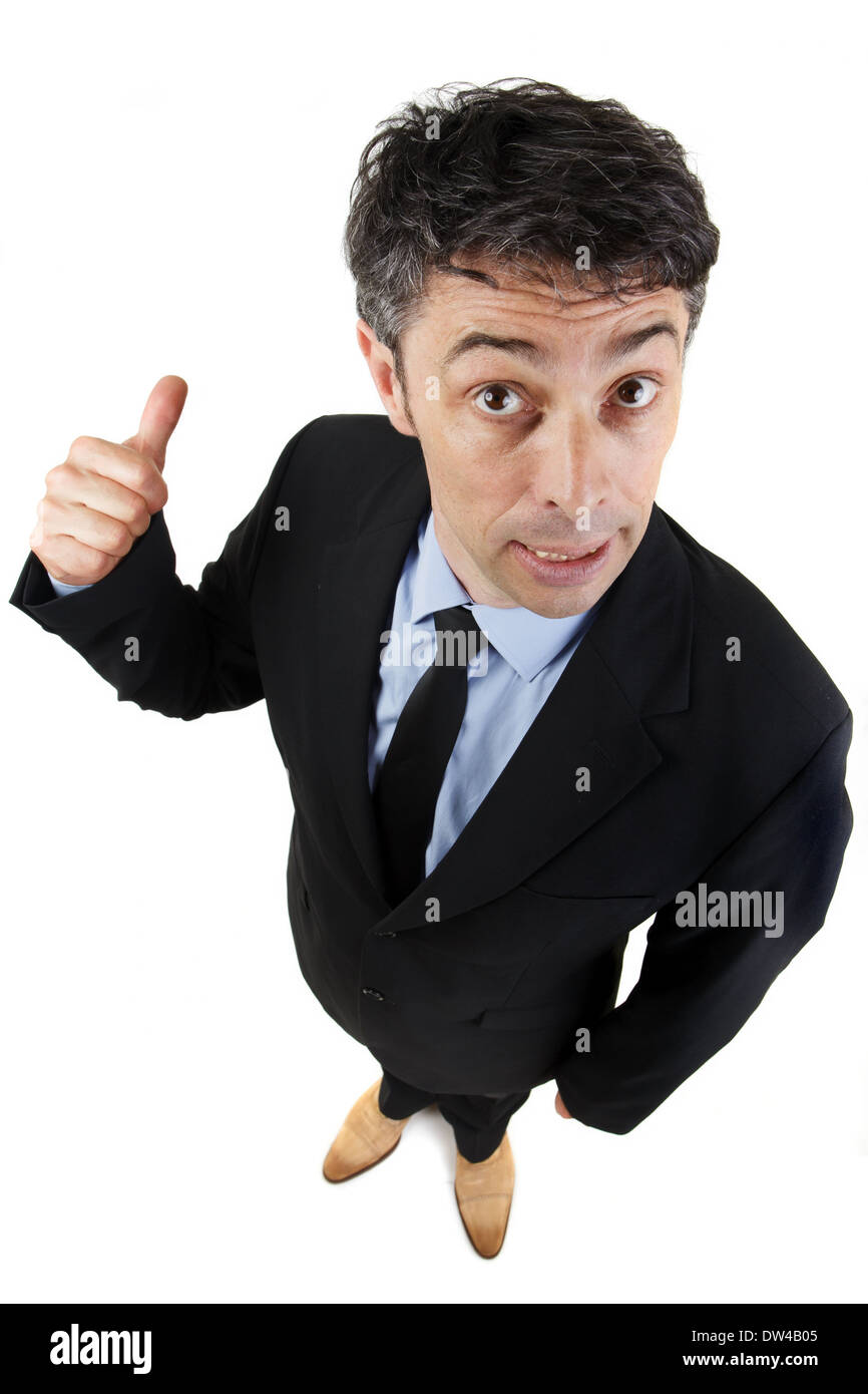 Unternehmer geben einen Daumen nach oben Geste beim geben der Kameras eines selbstgefälligen Blick auf seine Zulassung, Erfolg oder Leistung bedeuten Stockfoto