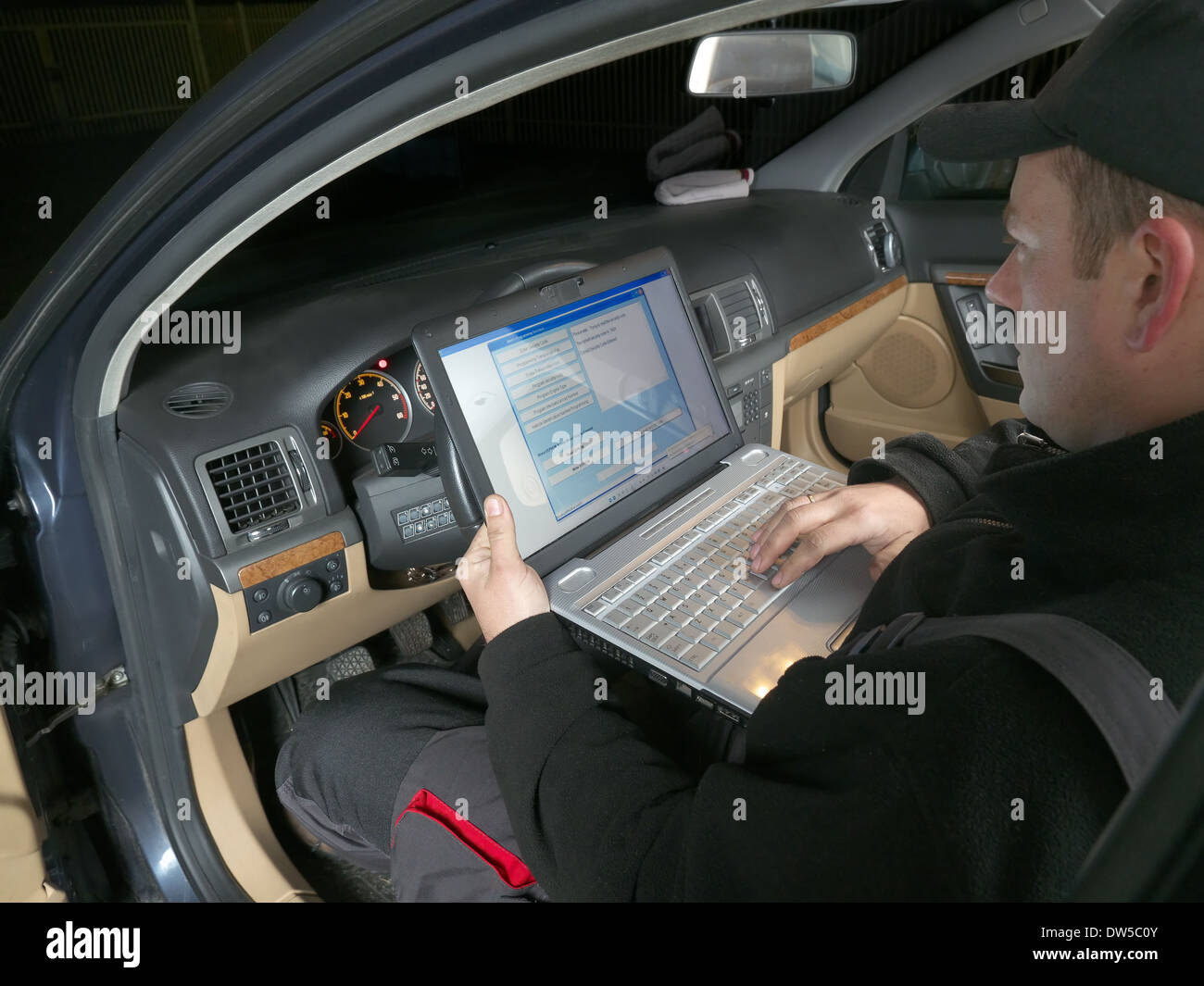 Kfz-Mechaniker, die Überprüfung der Fahrzeug-Identifizierungsnummer des Fahrzeugs mit Laptop angeschlossen, um die Auto-Bordcomputer Stockfoto