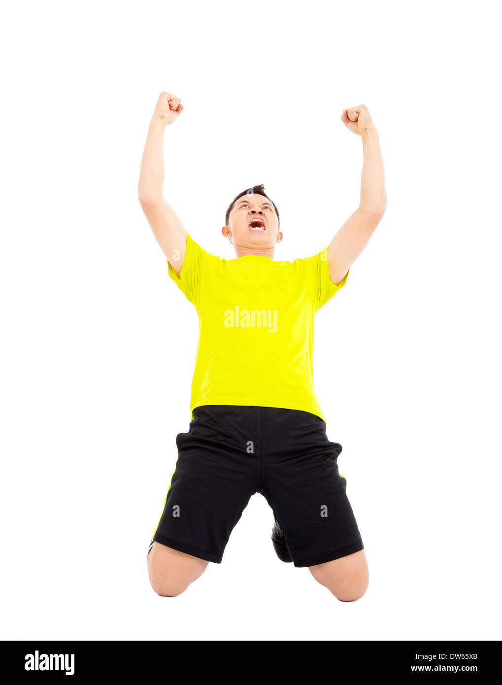 junge Fußballer hob die Hände, Sieger im Studio zu feiern Stockfoto