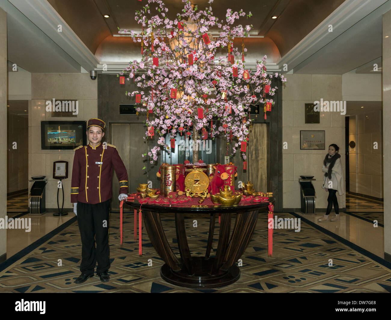 Kofferträger und Chinese New Year Dekorationen, Broadway Mansions Hotel Lobby, Shanghai, China Stockfoto