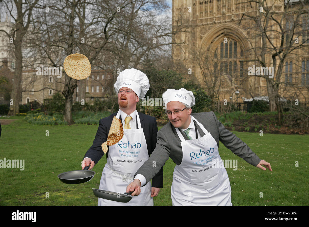 London, UK. 4. März 2014. Julian Huppert MP und Martin Horwood MP zu werfen Pfannkuchen. Die Reha Group arbeitet mit karitativen Einrichtungen, Unternehmen und Gemeinden zu Gleichstellung und Nachteile von Menschen im Vereinigten Königreich zu kämpfen. Dies ist das 17. Jahr des parlamentarischen Pancake Race, das Victoria Tower Gardens außerhalb der Houses of Parliament teilnimmt. Bildnachweis: Keith Larby/Alamy Live-Nachrichten Stockfoto