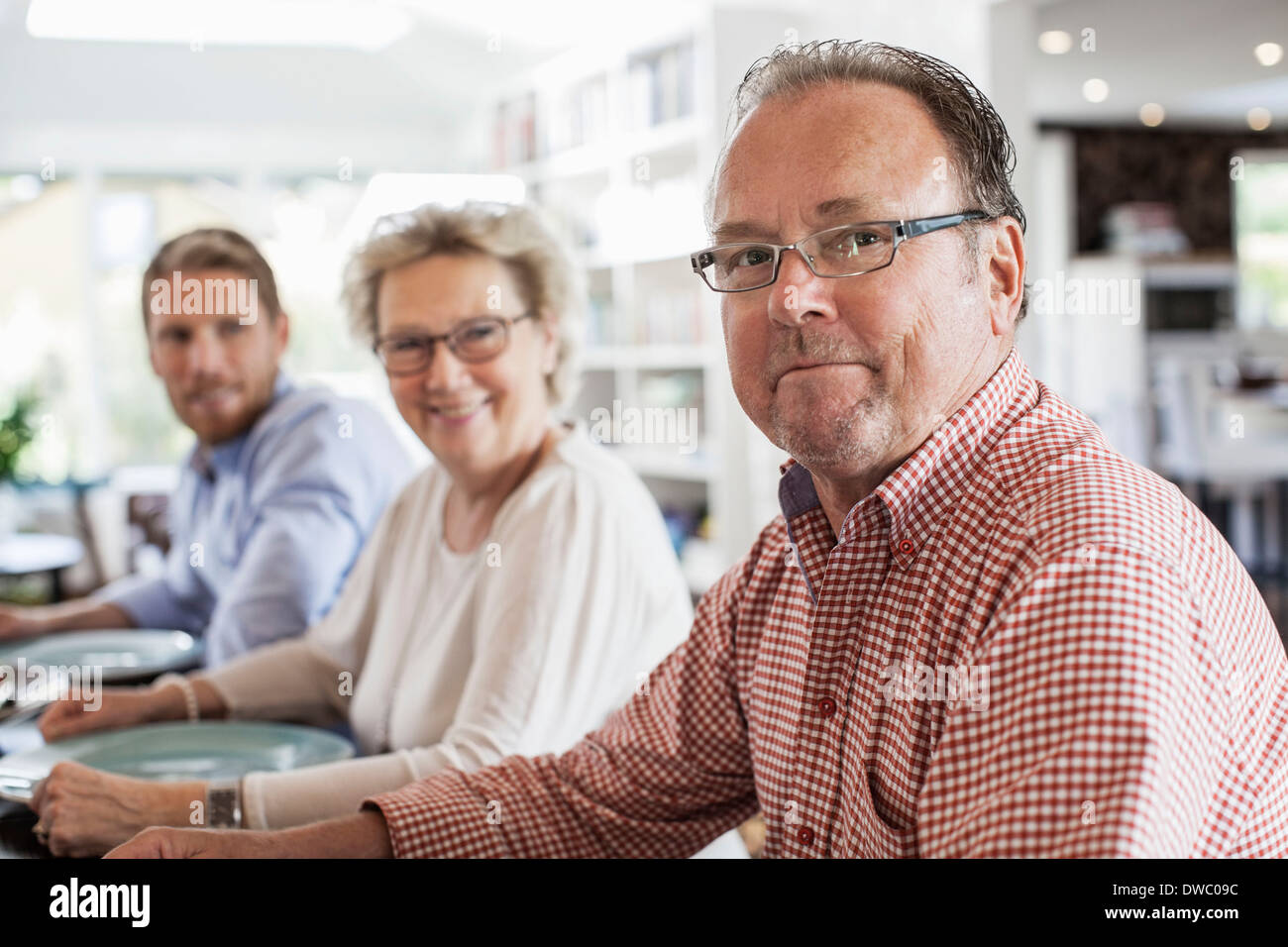 Porträt von zwei Generationen-Familie sitzt am Esstisch Stockfoto