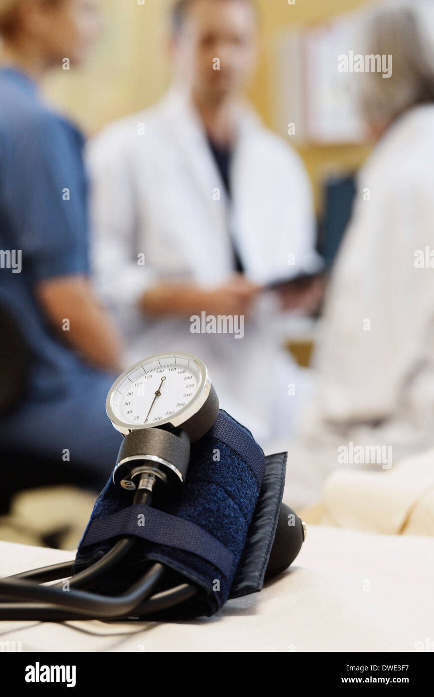 Blutdruck messen mit dem Ärzteteam besprechen im Hintergrund Stockfoto