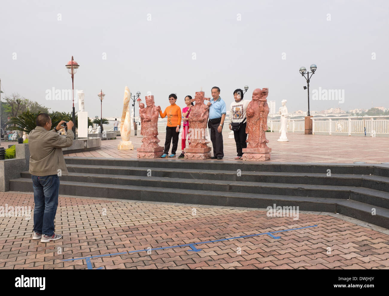 Touristen posieren für Foto von Kunstskulptur an der Uferpromenade in Danang Stockfoto