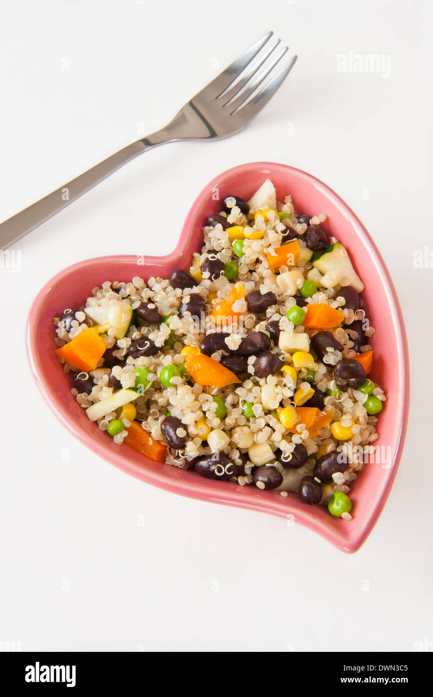 Herzförmige Schüssel gefüllt mit Quinoa und Gemüsesalat Stockfoto