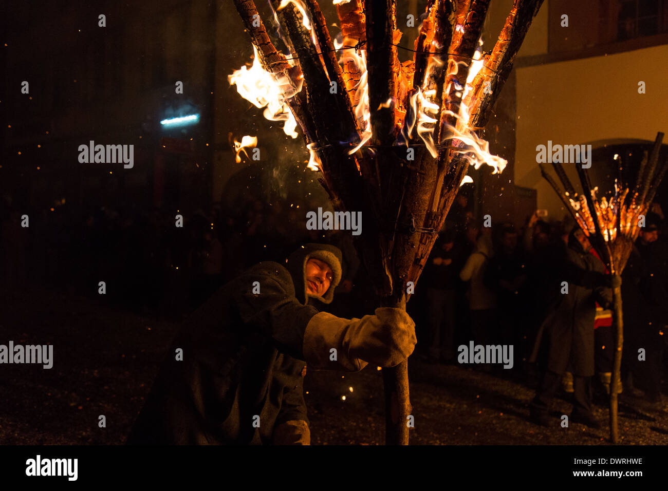 Photgraph eines Mannes mit einem brennenden Besenstiel bei der traditionellen Parade 'Chienbäse' für Fasnacht in Liestal, Schweiz Stockfoto