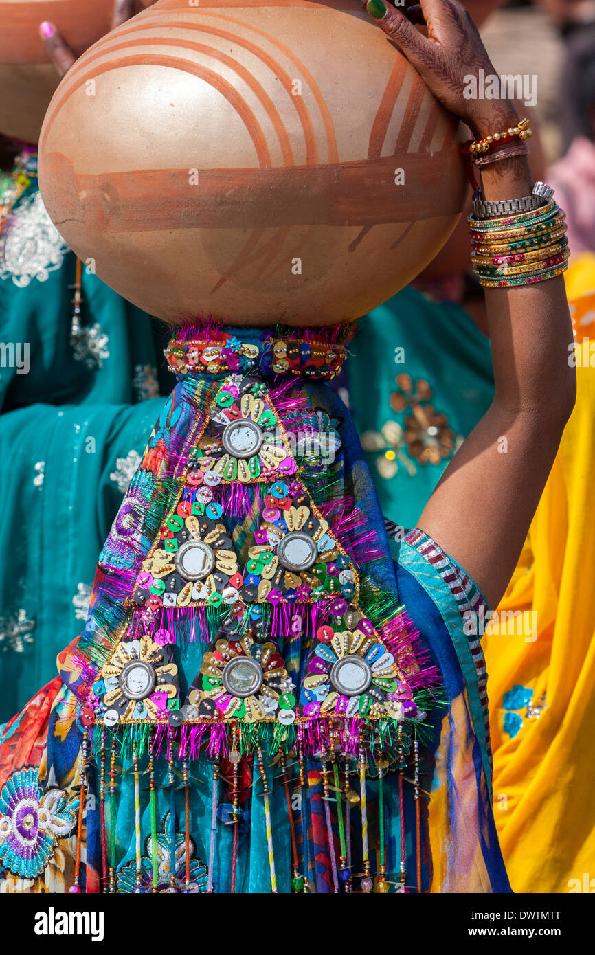 Abhaneri, Rajasthan, Indien. Bunten Pailletten Kopfschmuck einer Frau zu Fuß zum Haus eine Braut vor der Hochzeit Feier. Stockfoto
