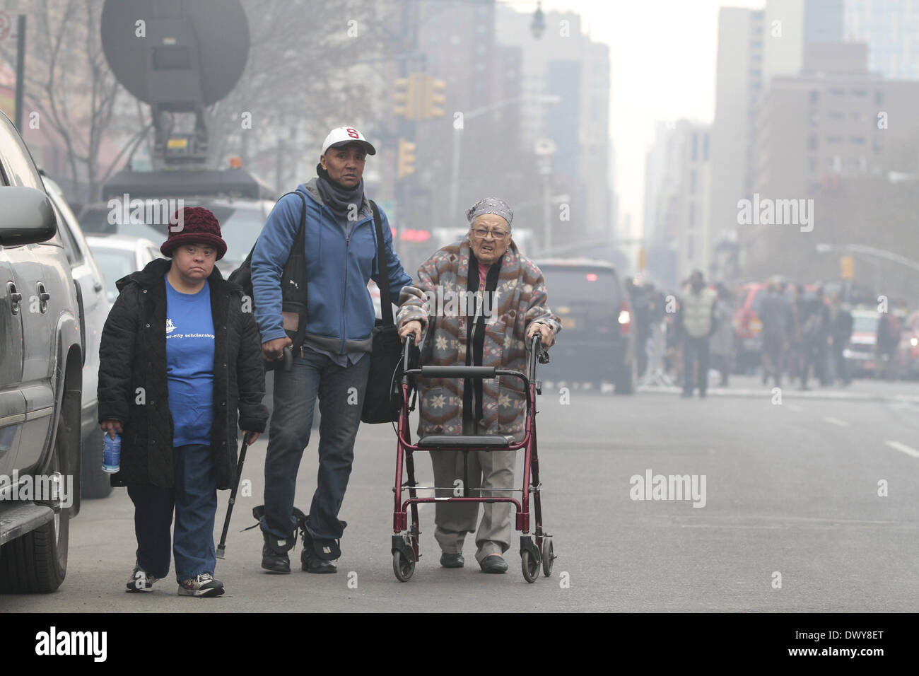 Manhattan, New York, USA. 12. März 2014. Szene eines mutmaßlichen Gasexplosion Leck am 1644 und 1646 Park Ave, zwischen East 116. und 117. Street, Harlem, NY am Mittwoch Morgen um ca. 09:30. Bisher acht Menschen sind bestätigten Toten, mehr als siebzig verletzt und drei Menschen noch vermisst. Bild: Eine vertriebenen Familie am Tatort von der Gebäude-Explosion. Angel Chevrestt/ZUMAPRESS.com/Alamy © Live-Nachrichten Stockfoto