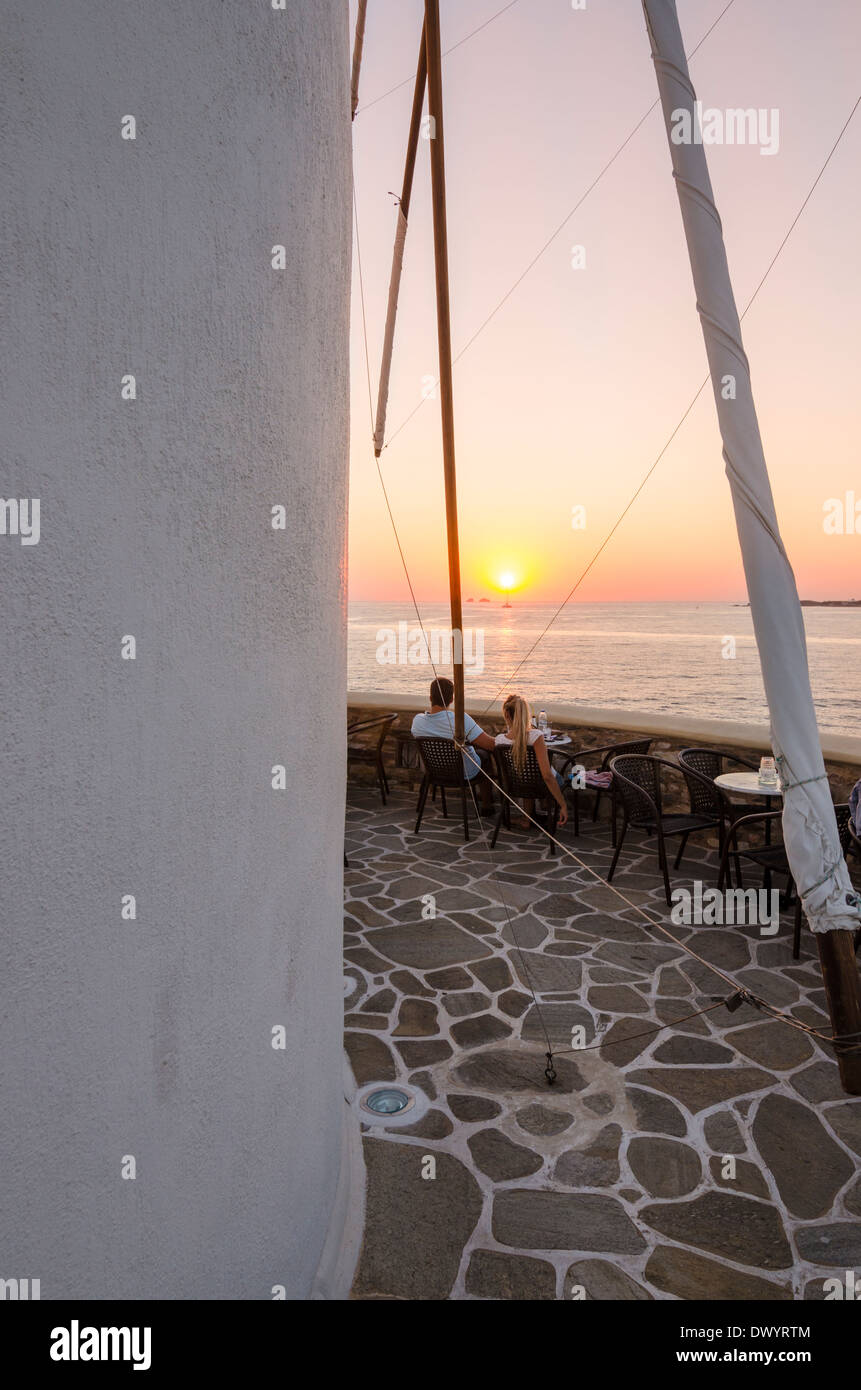 Paar genießt Sonnenuntergang Getränke an der Windmühle Café, Parikia, Paros, Griechenland Stockfoto
