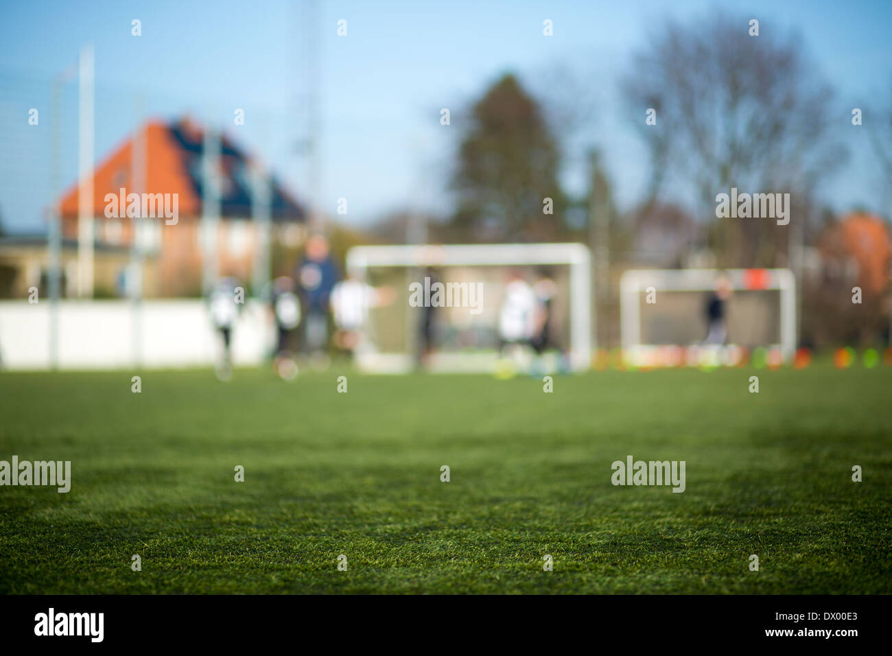 Nahaufnahme der Fußball-Rasen mit unscharfen Spieler im Hintergrund. Stockfoto