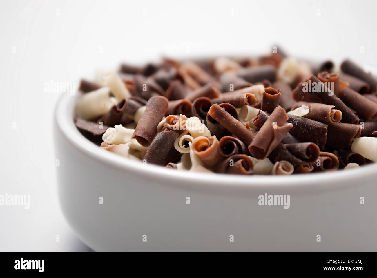 Weiße, dunkle und Milchschokolade Flocken in einem kleinen Porzellan-Topf Stockfoto