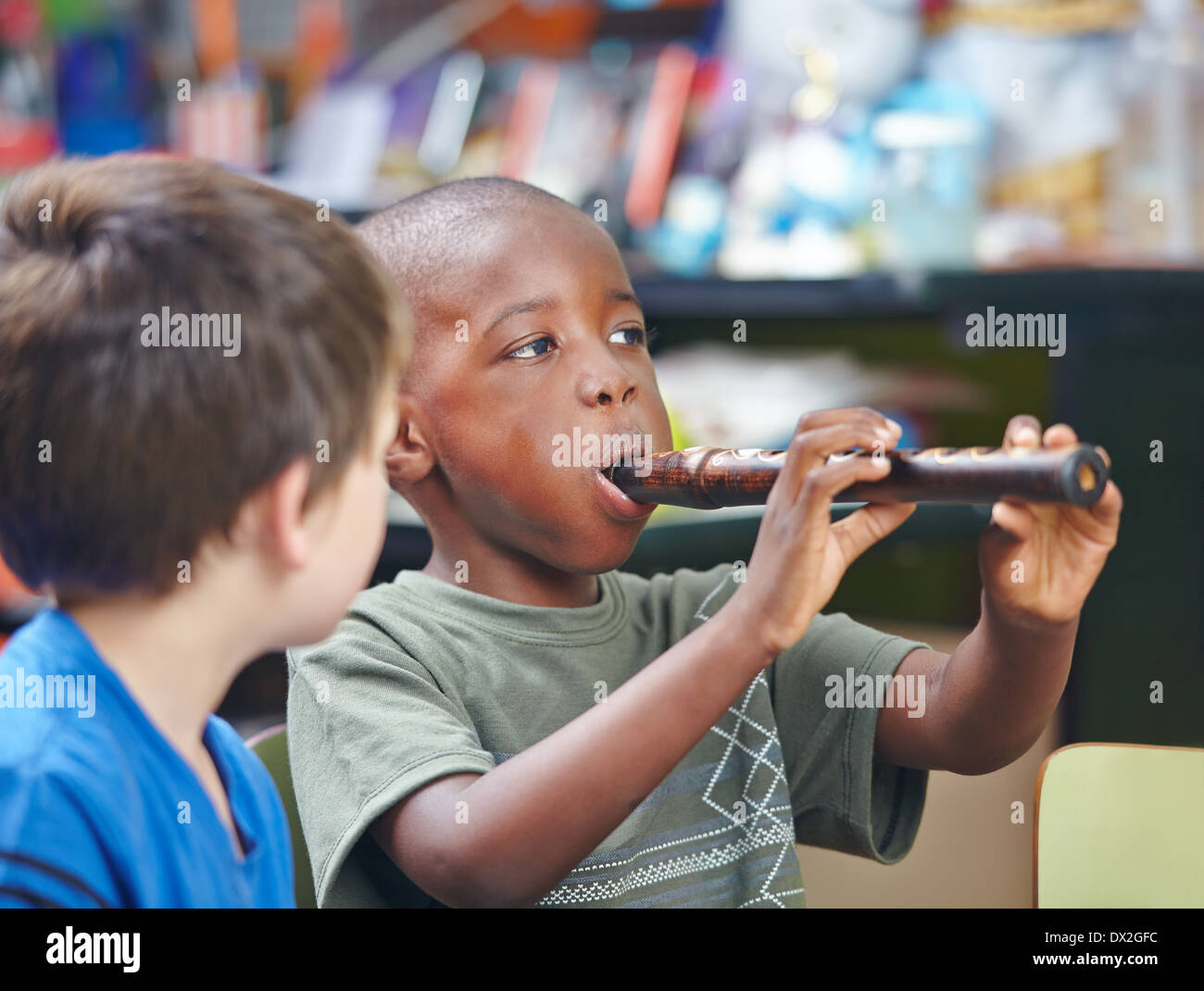 Afrikanischen Kindes Flötenspiel in einer Musikschule Stockfoto